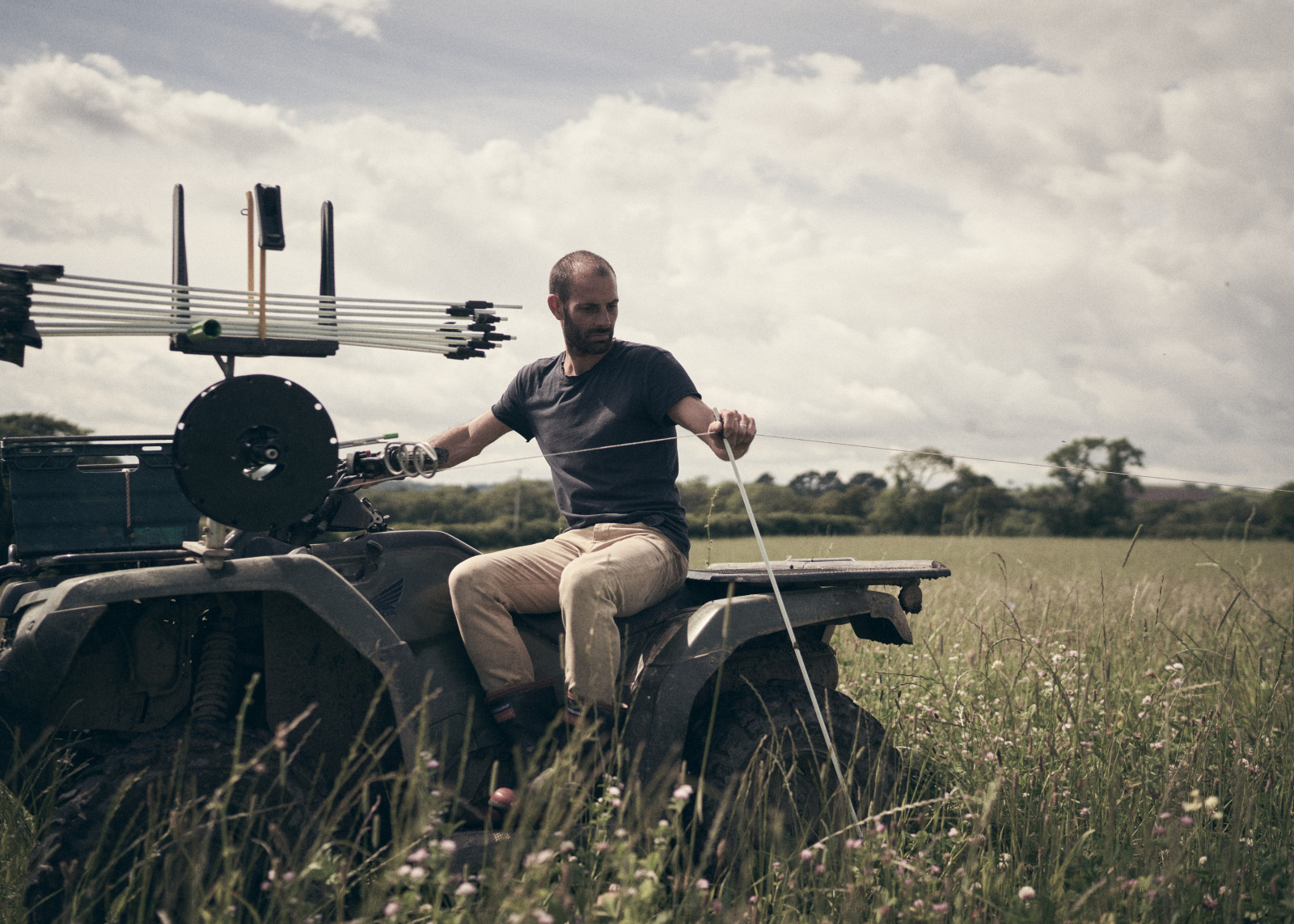 man sitting on a tractor in a field