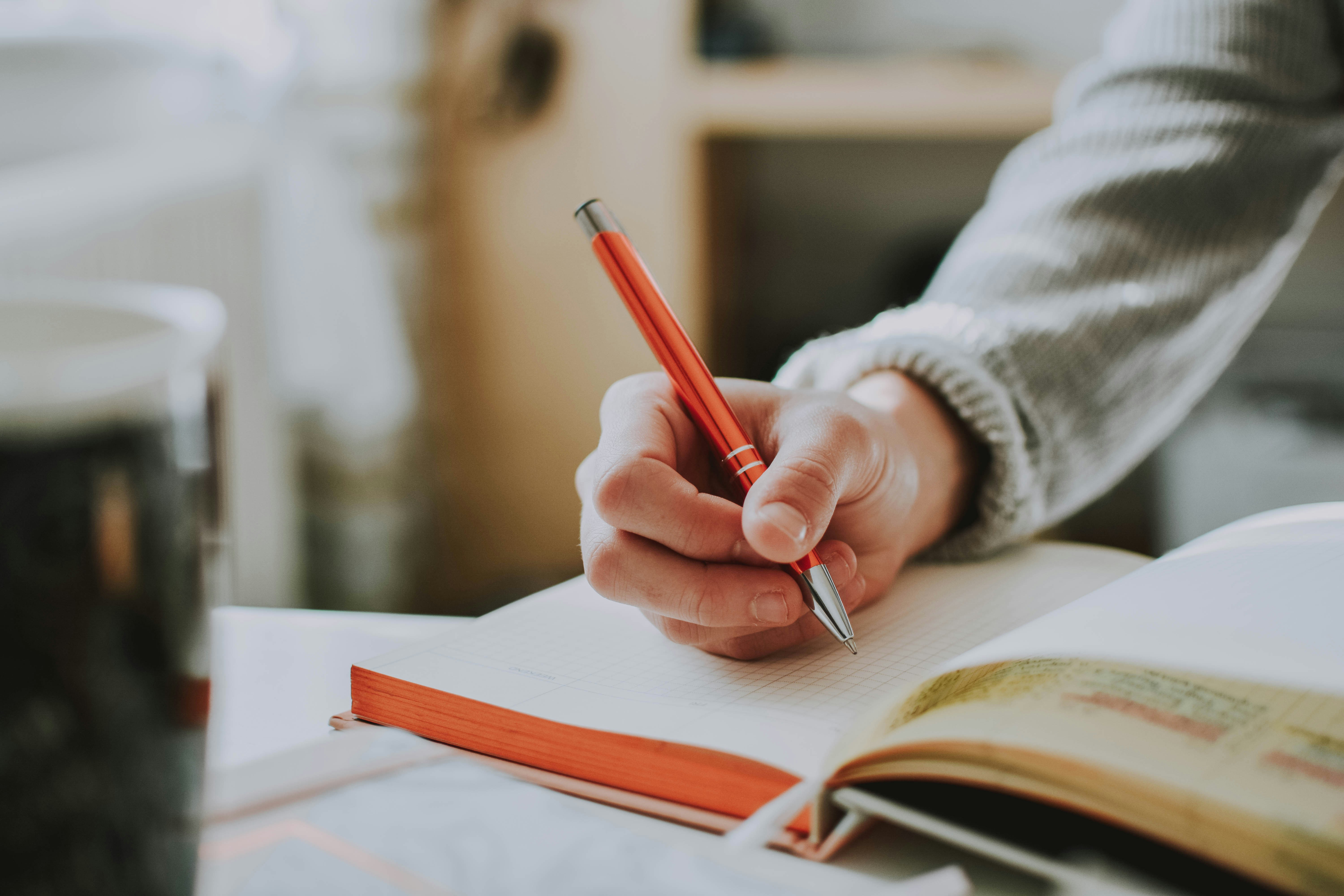 person writing with pen